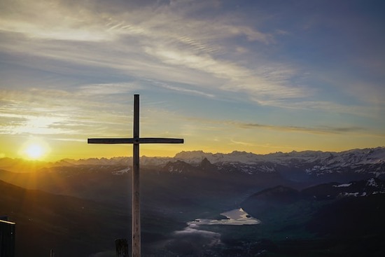 Cross on a hill representing salvation through Jesus A cross on a hillside is a common image because the cross has been a historical symbol of salvation for Christians.
