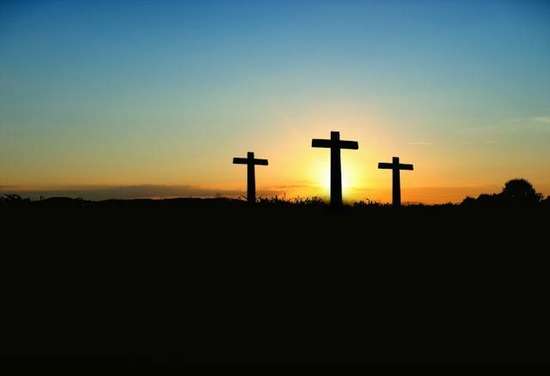 The silhouette of three crosses at sunset Three crosses are silhouetted against a beautiful sunset.