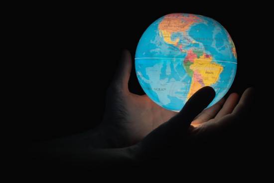 An image of hands holding an illuminated globe shows that the entire world will experience Christ's return at the same time. And it'll be so grand that all events on Earth will stop as the world watches the events in the sky unfold.