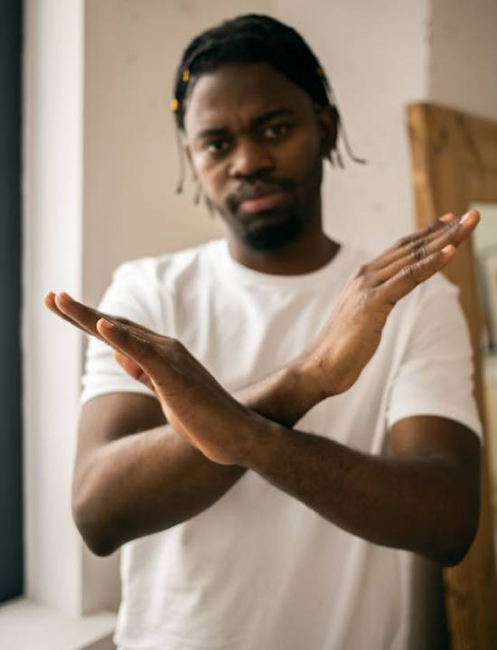The image of a man crossing his arms in from of him like an X represents those who don't choose Jesus, and wouldn't be happy in Heaven. Though Jesus wants to take all God's children home, He gives us the freedom of choice.